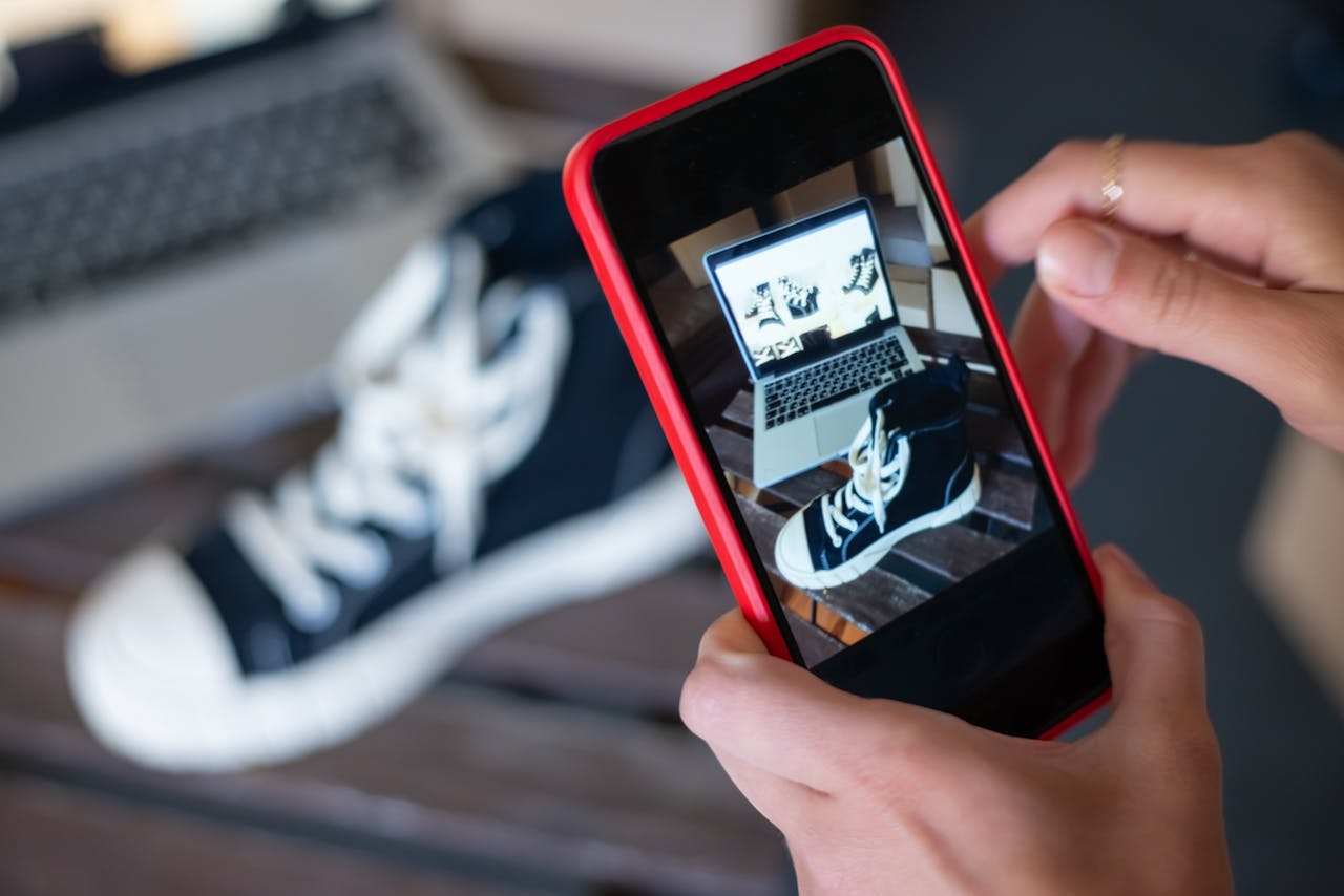 Person taking a Photo of a Black Shoe